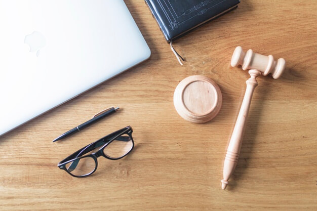 Wooden table with laptop, mallet and glasses