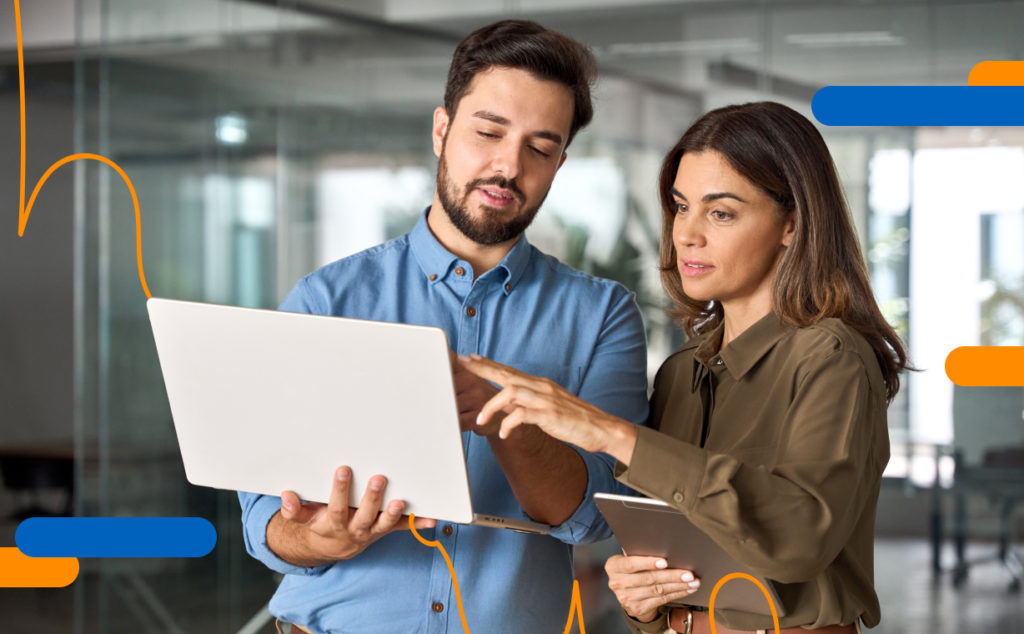 Two professionals reviewing digital processes to improve administrative efficiency with the help of technology