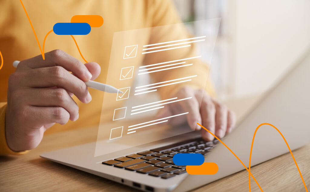 Hands ticking off a digital checklist on a laptop, symbolising compliance with the requirements of the Anti-Fraud Act 2026.